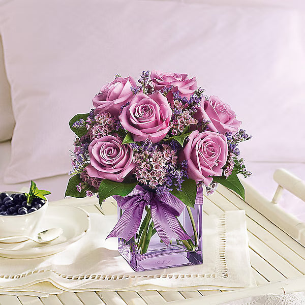 Bouquet of pink roses with a purple ribbon