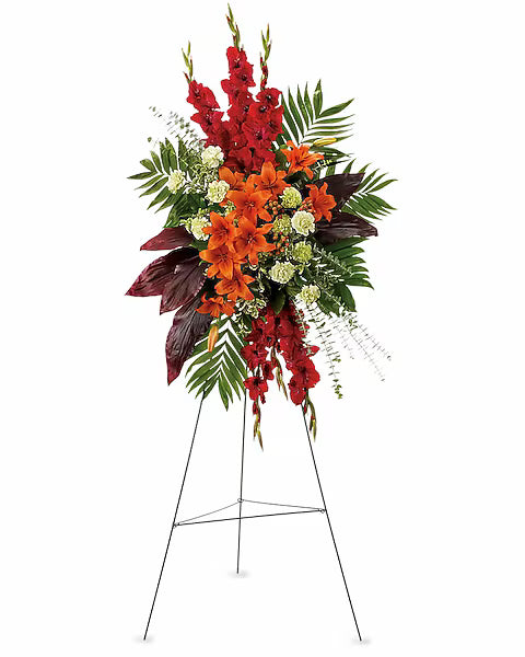 Floral arrangement with red, orange, and green flowers on a stand