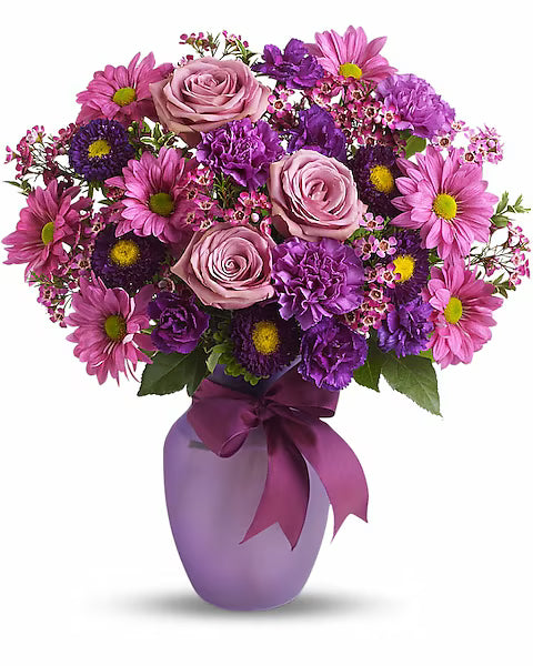 Vase of fresh roses on a wooden surface.