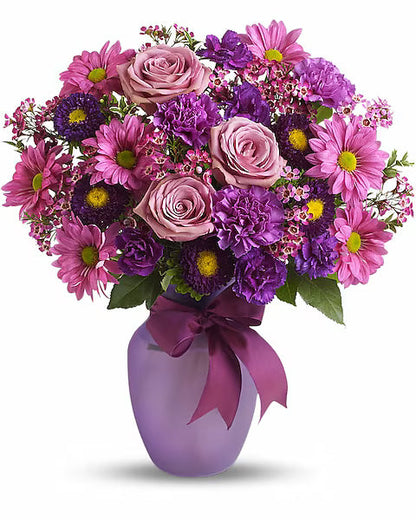 Vase of fresh roses on a wooden surface.