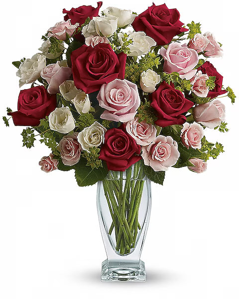 Mixed rose bouquet in a clear vase on white background